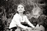 Josephine & Paxton Clark play in Fall leaves